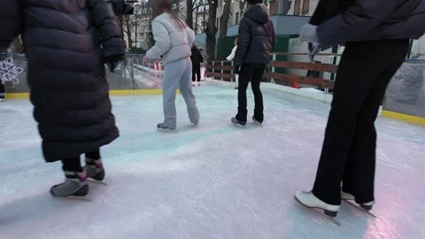 Ice skating POV around public city park in winter family fun activity Stock Footage 325376833