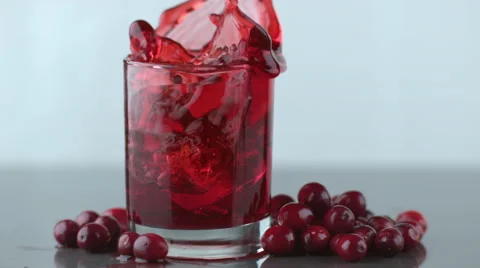 Ice splashing into cranberry juice in slow motion; shot on Phantom Flex 4K at Stock Footage