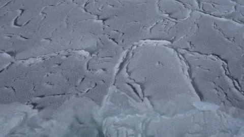 Ice is splitting. Cracks in ice. Top-down view. Beautiful patterns on ice Stock Footage 218592810