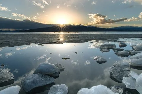 Ice stacks in horizontal image at Vineyard Beach on Utah Lake in Utah at su.. Stock Photos