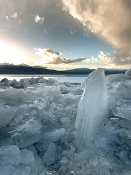 Ice stacks in vertical image at Vineyard Beach on Utah Lake in Utah at suns.. Stock Photos