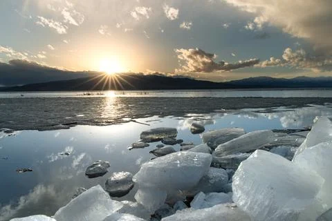 Ice stacks in vertical image at Vineyard Beach on Utah Lake in Utah at suns.. Stock Photos