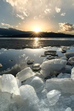 Ice stacks in vertical image at Vineyard Beach on Utah Lake in Utah at suns.. Stock Photos