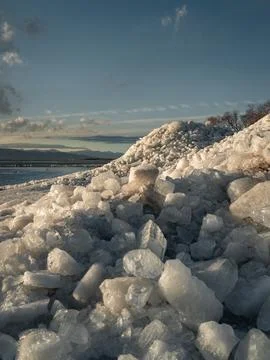 Ice stacks in vertical image at Vineyard Beach on Utah Lake in Utah at suns.. Stock Photos