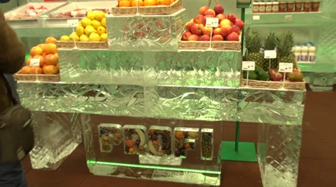 Ice store, shop made of ice, fresh fruits on ice shelves, blocks, ice carving Stock Footage 33705133