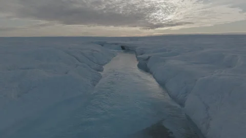 Ice Stream Leading to a Moulin at Sunset Aerial Stock Footage 292941446