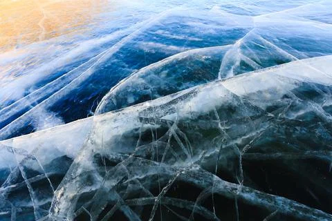 Ice surface with deep cracks on lake Baikal. Stock Photos