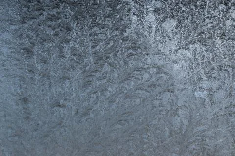 Ice texture background. Frozen window on a winter night. Stock Photos