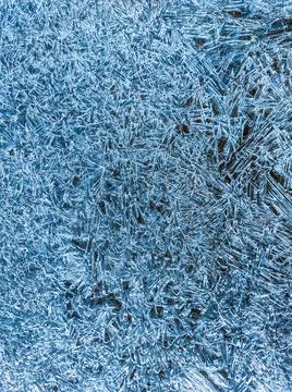 Ice texture. Blue winter background with water frozen by the cold. Vertical n Stock Photos