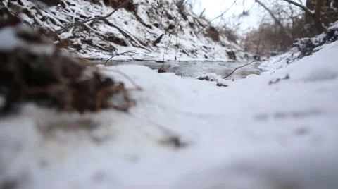 Ice water running in a fast spring stream. Snow melting on steep creek banks Stock Footage 47526272