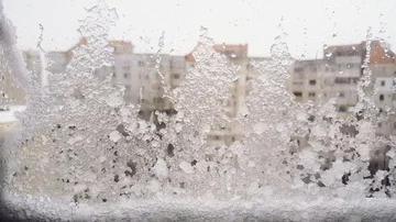 Ice on the window and snow in the city Stock Footage 85689558