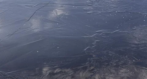 Ice on a winter river with a reflection of clouds Stock Photos