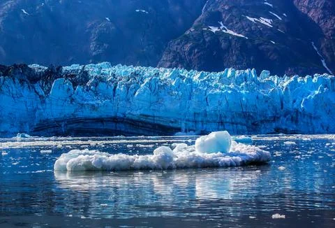Iceberf floating in front of glacier surface in glacier bay national park, al Stock Photos