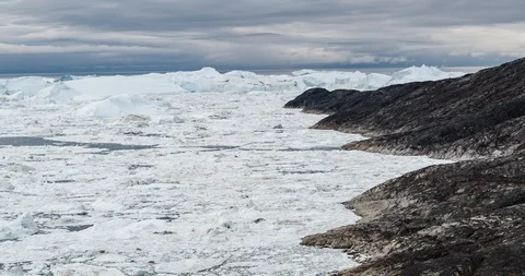Iceberg and ice from glacier in dramatic arctic nature landscape on Greenland Stock Footage 112885954