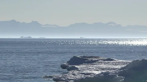 Iceberg on the Arctic Ocean with mountain in the background, Greenland Video stock 102510492