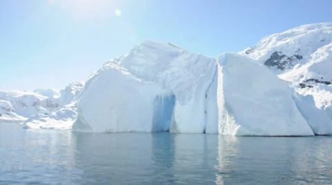 Iceberg with cave and mountain behind it, Antarctic 스톡 동영상 33580304