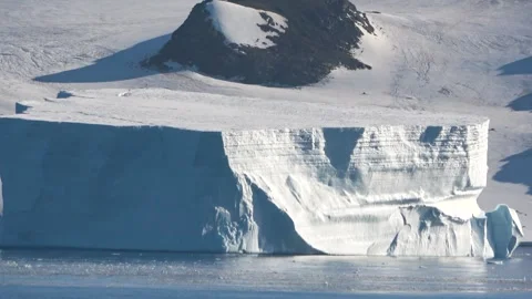 Iceberg drifting with mountain background Antarctica, 4K Stock Footage 332372781