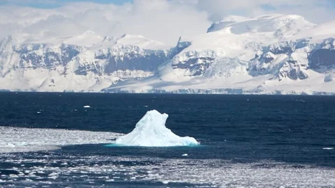 Iceberg drifting with mountains motion Antarctica, 4K Stock Footage 332371547