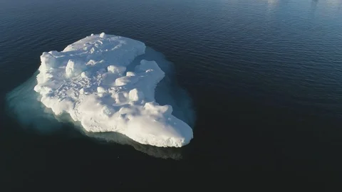 Iceberg float in clear water ocean drone above view Stock Footage 100051092