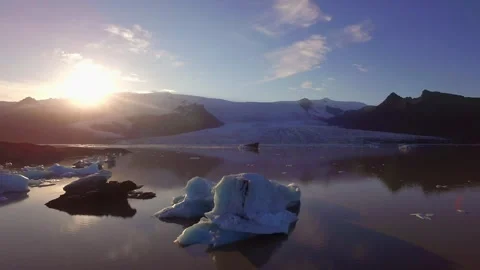 Iceberg floating on glacial lagoon at sunset in Iceland Stock Footage 330281622