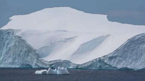 Iceberg with glacier background drifting Antarctica, 4K Stock Footage 332372841