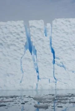 Iceberg with large cracks. Stock Photos
