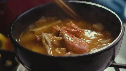 Iceberg lettuce leaf falling on a bun while making a burger. Stock Footage 121744663