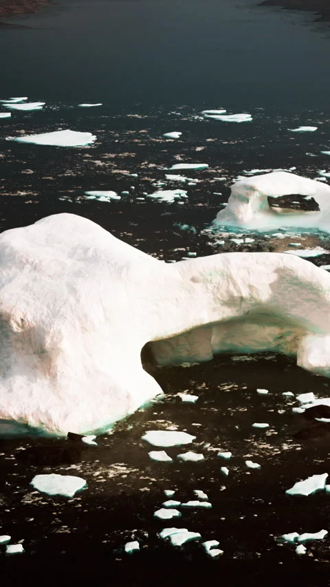 Iceberg with a natural arch floating in dark water Stock Footage 341270337