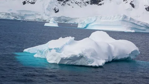 Iceberg passing left to right ocean Antarctica, 4K Stock Footage 332372815