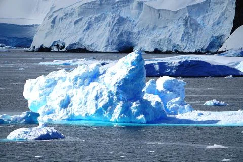 The iceberg is like a pile of salt, the bottom of the iceberg is crystal blue Stock Photos