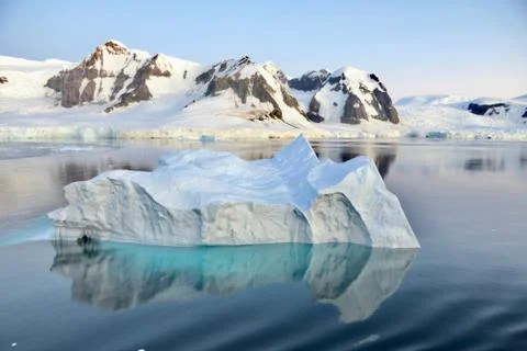 Iceberg reflection, calm blue ice water, evening light, glacier, Antarctica Stock Photos