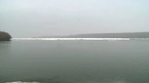Iceberg on a river, river babk and ice in distance Stock Footage 11165167