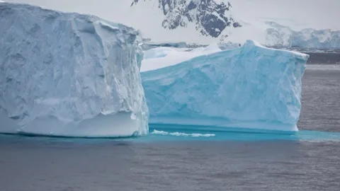 Icebergs close passing blue ice Antarctica, 4K Stock Footage 332372806