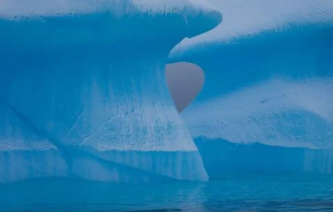 Icebergs with eroding and changing form drifting on the water, antarctica Stock Photos