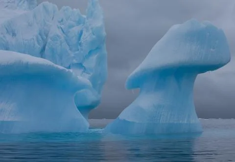 Icebergs with eroding and changing form drifting on the water, antarctica Stock Photos