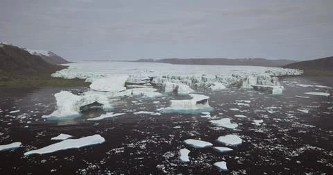 Icebergs float in tranquil waters near a glacial retreat in remote landscape Stock Illustration