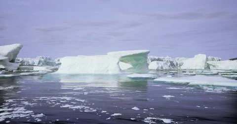 Icebergs floating in calm waters during twilight hours in a serene landscape Stock Illustration
