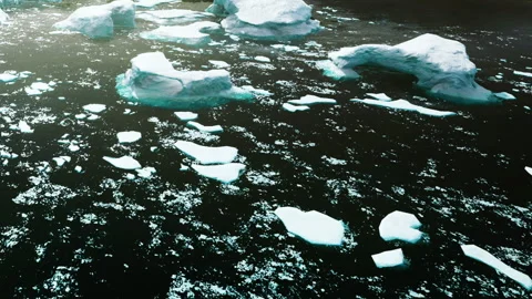 Icebergs floating in dark water during daytime in a remote location Stock Footage 340027826