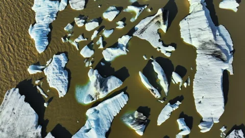 Icebergs, Large Chunks of Ice Float in Brown Glacier Lagoon. Iceland. Global 스톡 동영상 247940805