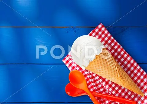 Icecream cone on checkered napkin Stock Photos
