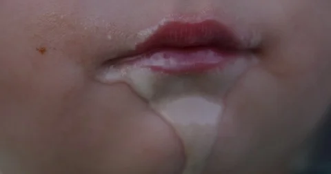 Icecream dripping off baby boys chin - extreme close up Stock Footage