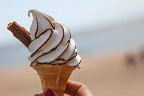 An icecream with a flake and chocolate sauce. Stock Photos