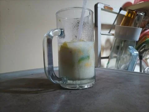 Iced avocado milk in a large white glass Stock Photos