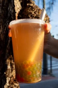 Iced bubble tea held by hand in nature Stock Photos