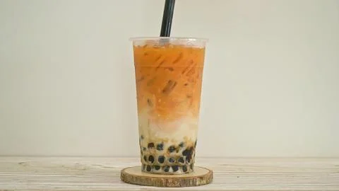 Iced bubble tea with tapioca pearls and orange milk drink Stock Photos