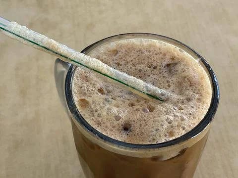 Iced Cham Coffee Tea Mix With Frothy Foam And Straw Stock Photos