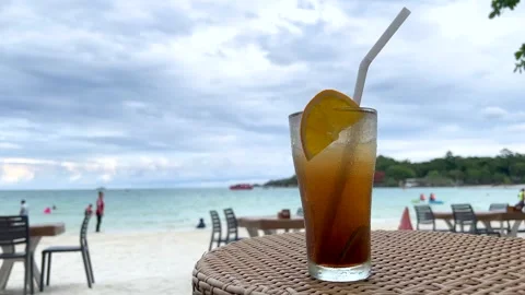 Iced Cocktail on Outdoor Table Overlooking Rayong Beach Stock Footage 313184885