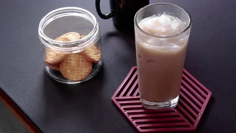 Iced coffee and biscuits in a transparent glass on a black background Stock Footage 236850042
