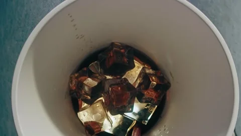 Iced Coffee Beverage Held in a Cup with a Straw Viewed from a First Person View 库存影片 331098579