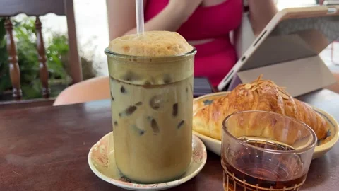Iced coffee breakfast coffee with foam stirring cappuccino in glass. Milkshake Stock Footage 314498824